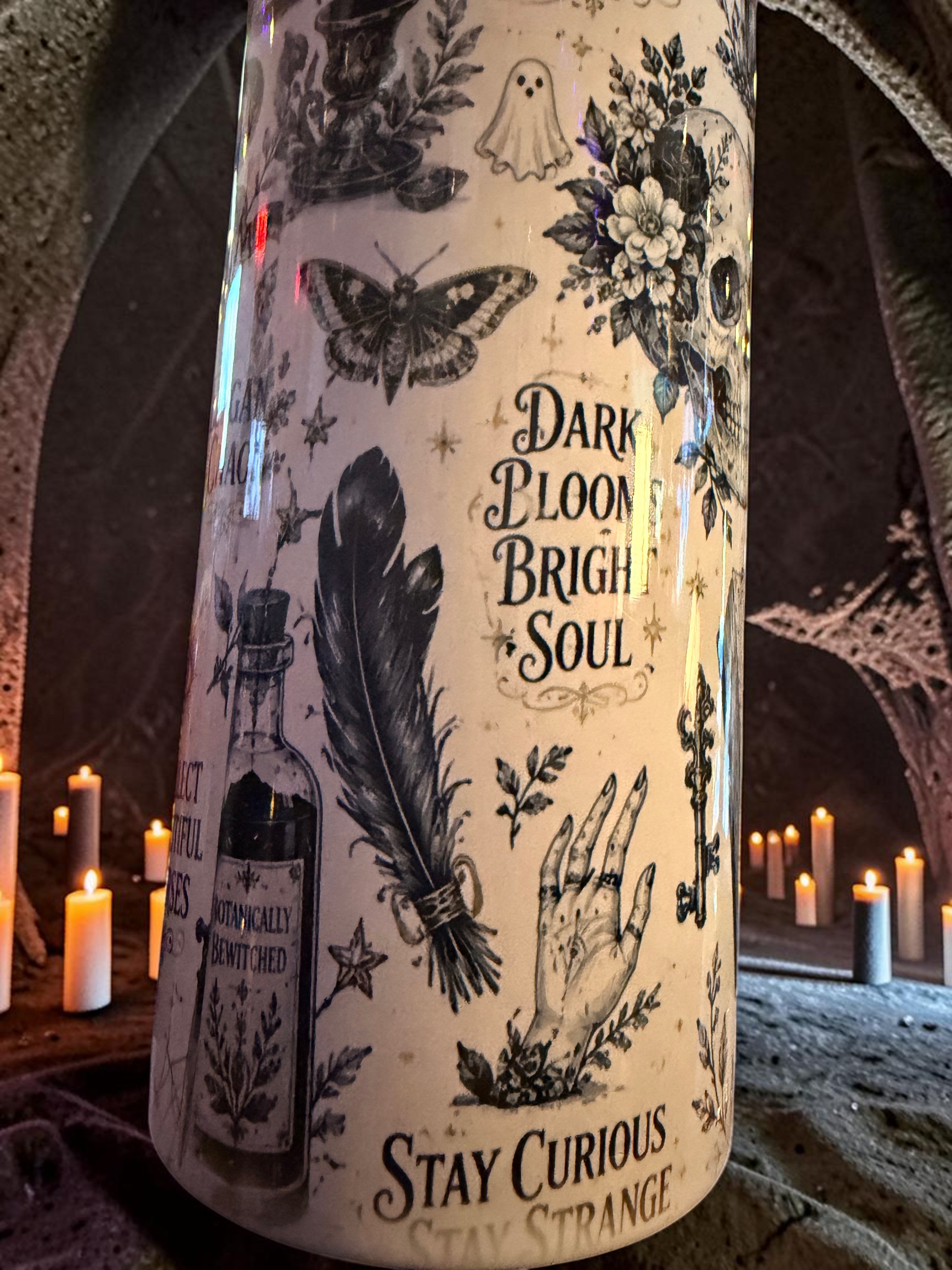 Halloween-Emporium 30oz grimoire tumbler with occult illustrations of skulls, moths, and potions on a cream background