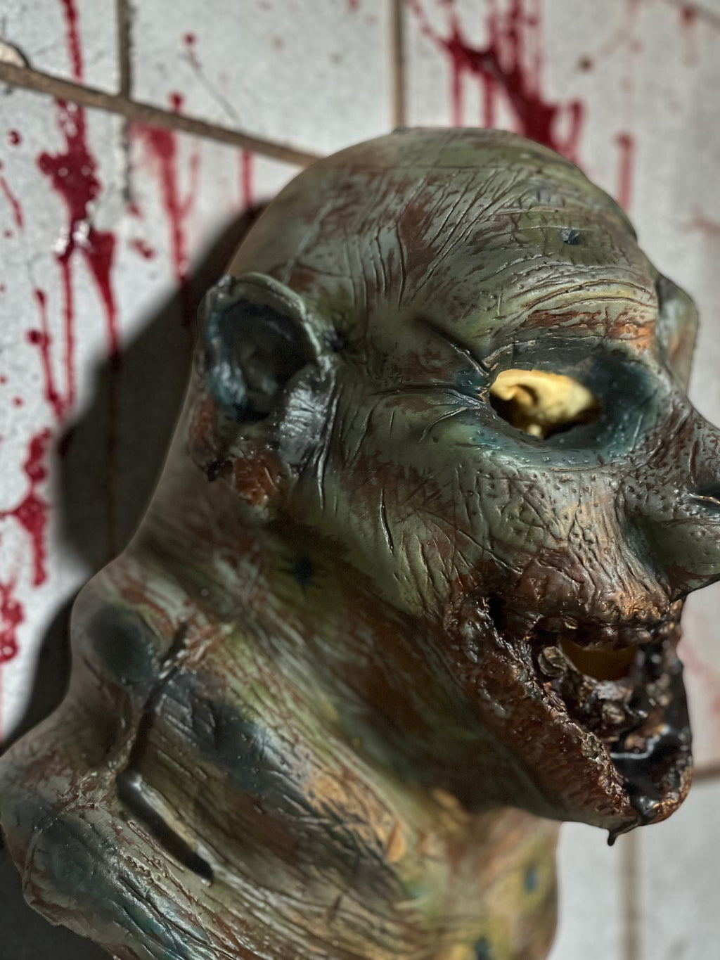 Halloween-Emporium Las Vegas Undead Gus latex zombie mask with hand-painted gory details and realistic skin texture.