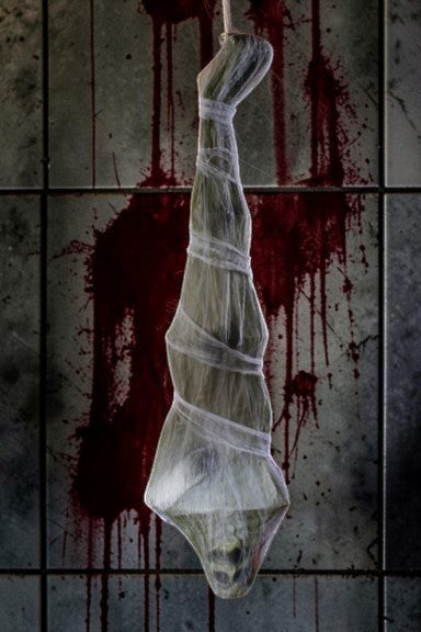 Halloween-Emporium 72-inch hanging skeleton wrapped in translucent white webbing against a bloody tiled background.