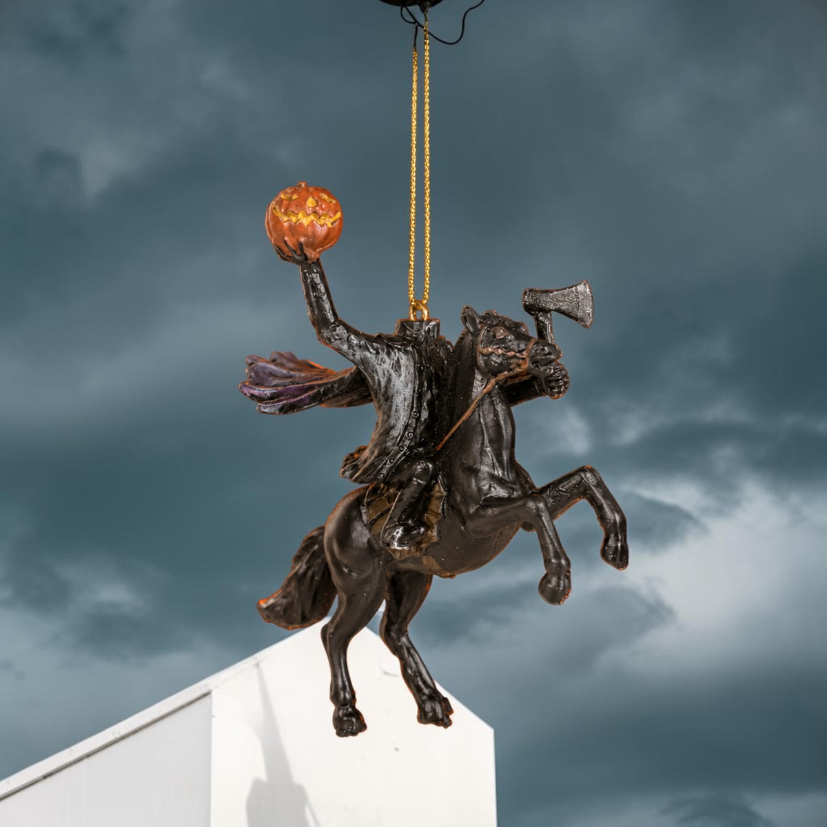 Halloween-Emporium Headless Horseman ornament with a jack-o'-lantern and axe, featuring a dark, detailed gothic design.