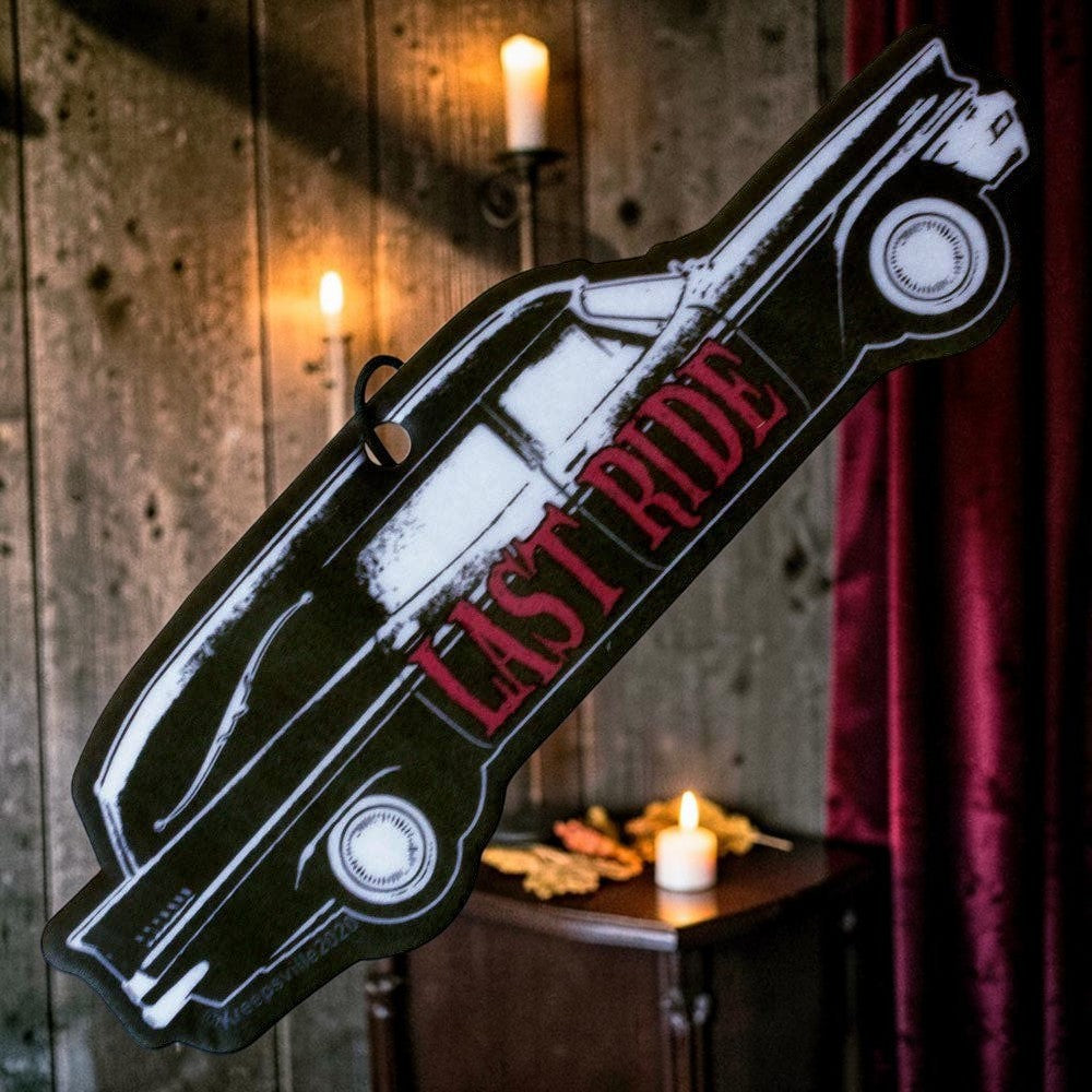 Halloween-Emporium Hearse Last Ride air freshener with gothic car silhouette and red text hanging in a candlelit room