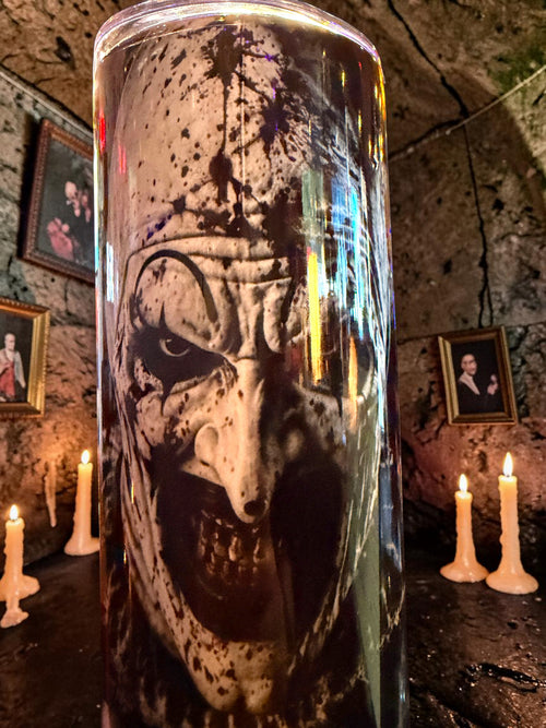 Halloween-Emporium 30oz Art tumbler featuring a dark horror clown graphic, set against a gothic candlelit background.