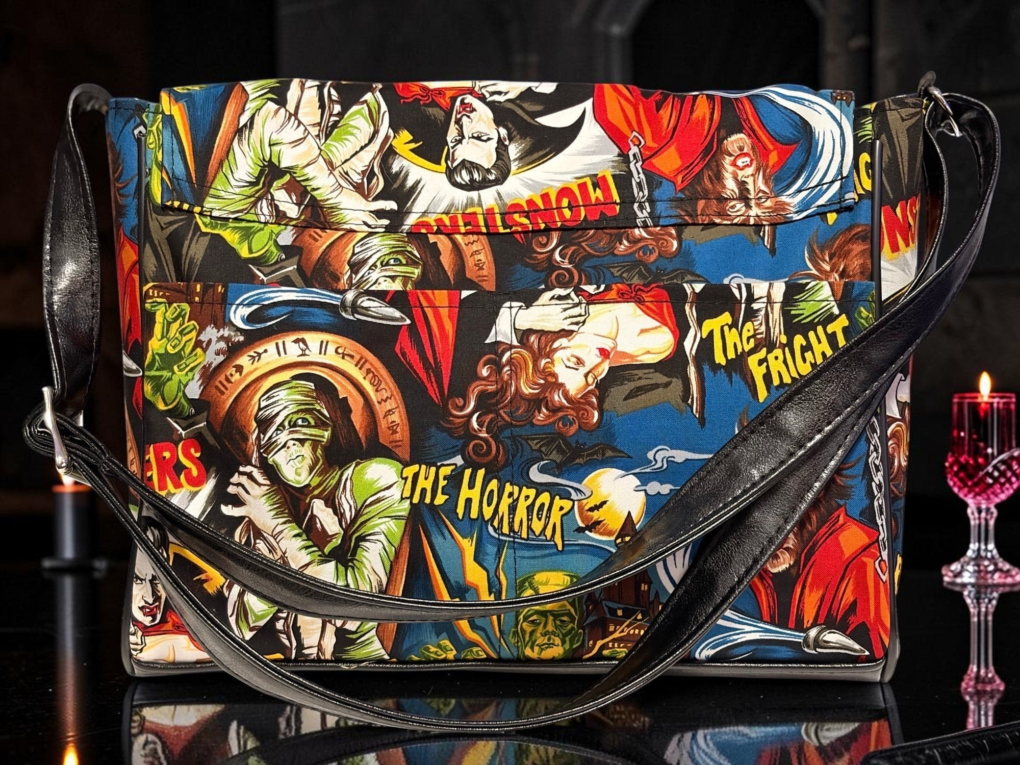 Halloween-Emporium messenger bag featuring a vibrant classic horror comic book print with monsters and gothic motifs.