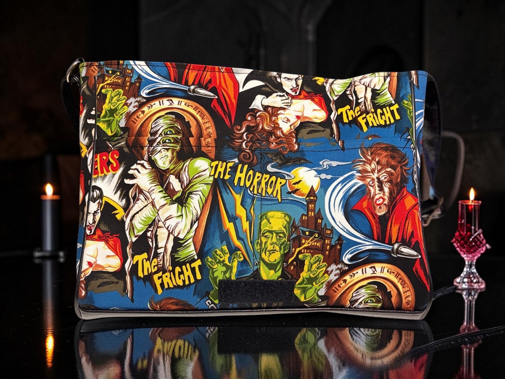 Halloween-Emporium messenger bag featuring a vibrant classic horror comic book print with monsters and gothic motifs.
