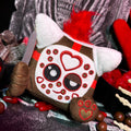 Halloween-Emporium cube-shaped horror plush with a hockey mask design, red faux-fur, and a small toy blade.