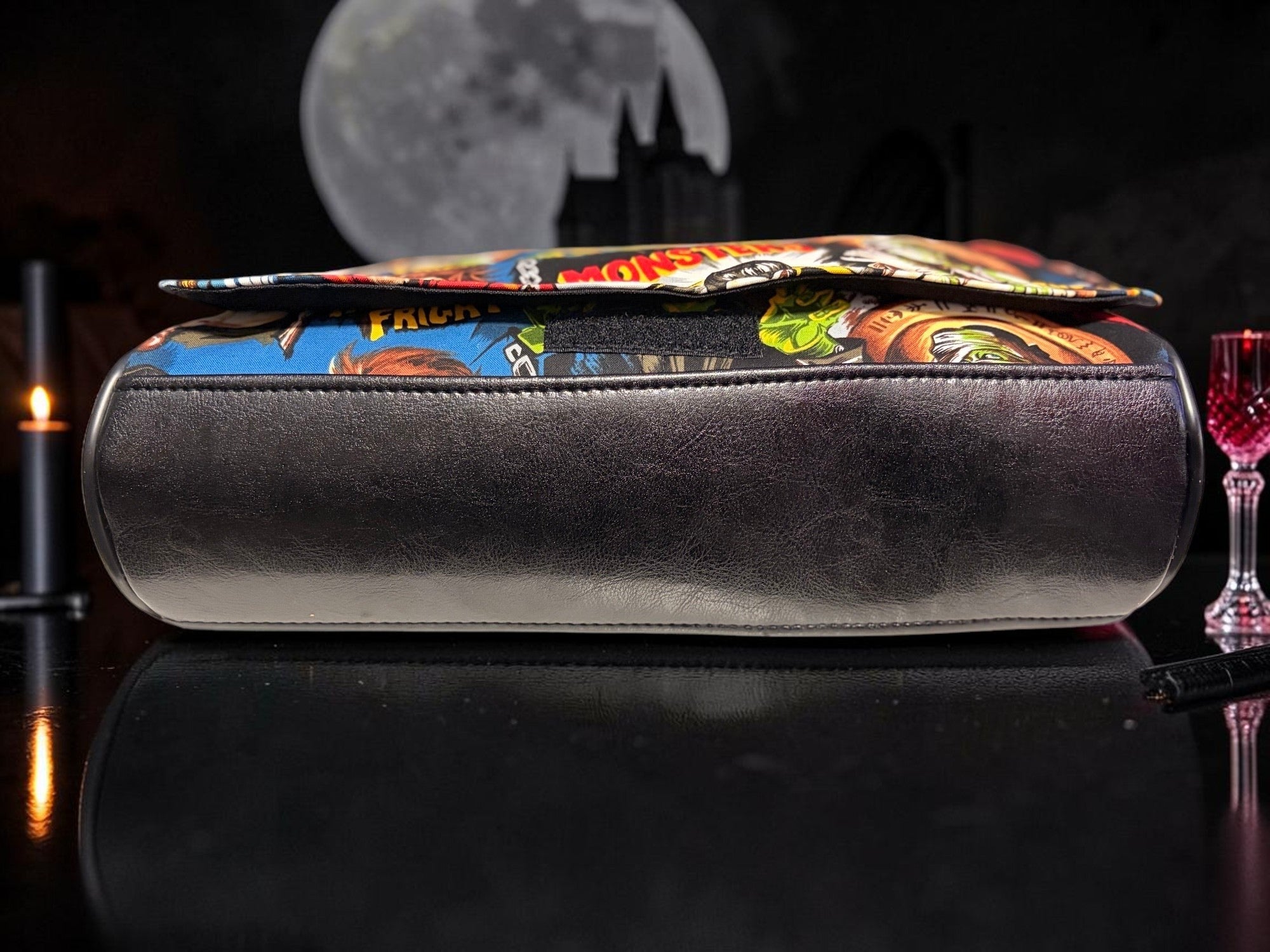 Halloween-Emporium classic horror messenger bag featuring a vibrant comic book monster print and black trim.