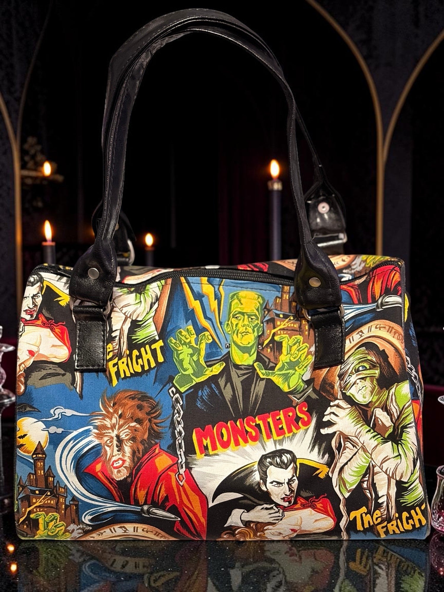 Halloween-Emporium classic horror handbag featuring vintage monster comic book art with black leather handles.