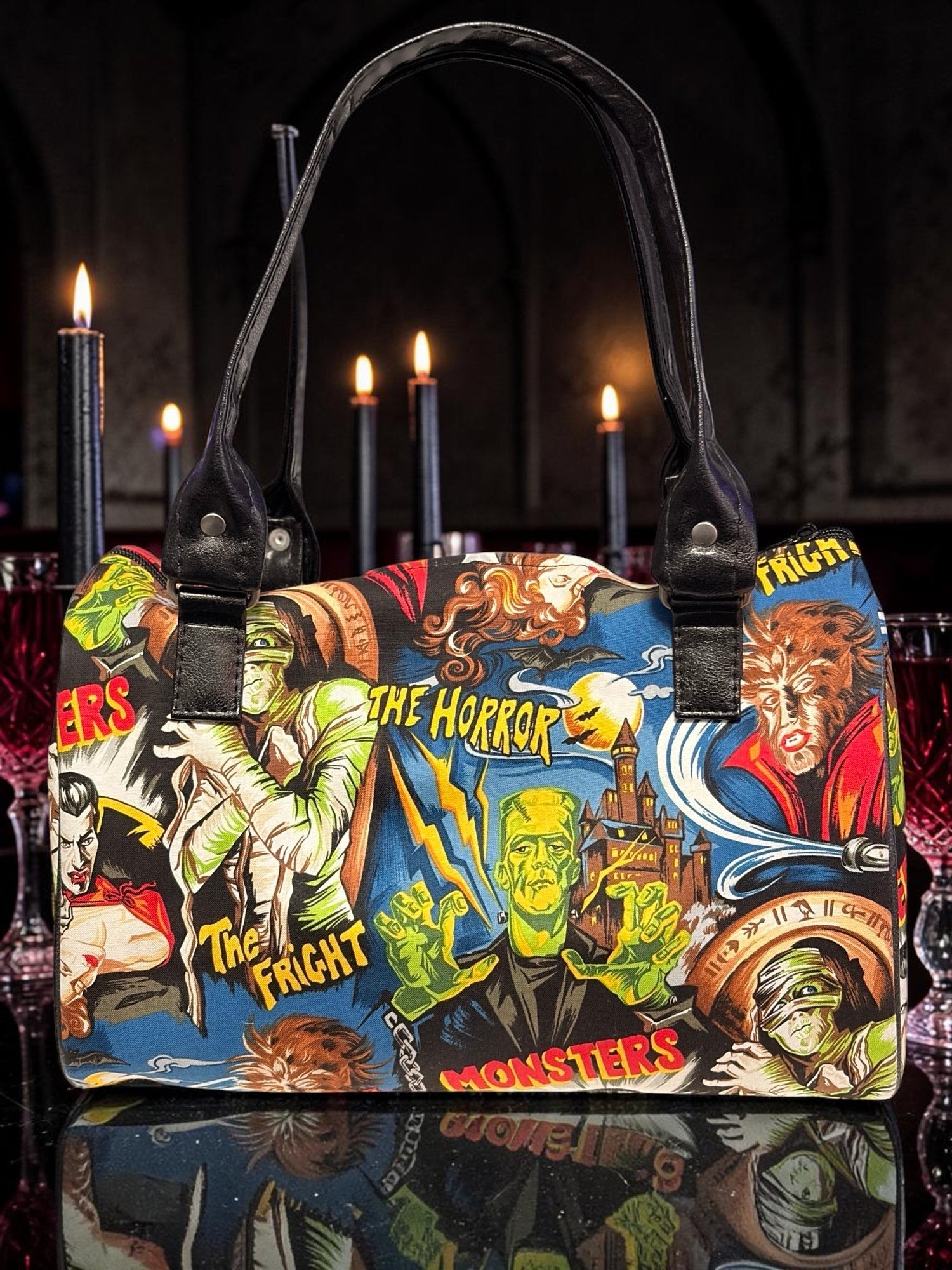 Halloween-Emporium purple handbag featuring a vintage classic horror movie monster print with black leather handles.