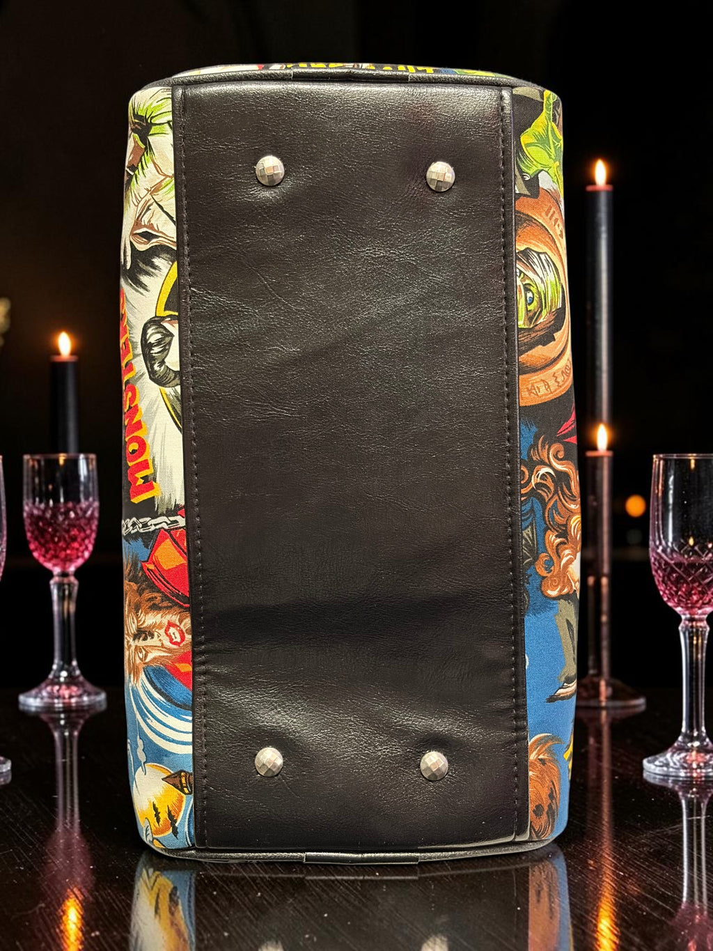 Halloween-Emporium black handbag featuring classic horror movie monster graphics and metal base studs