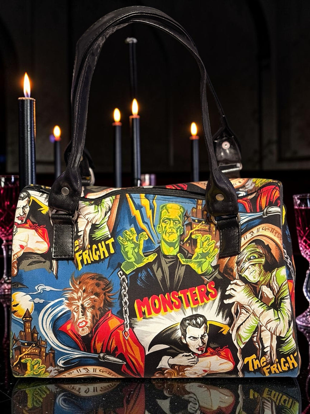 Halloween-Emporium purple handbag featuring classic horror movie monster graphics and black leather-look handles