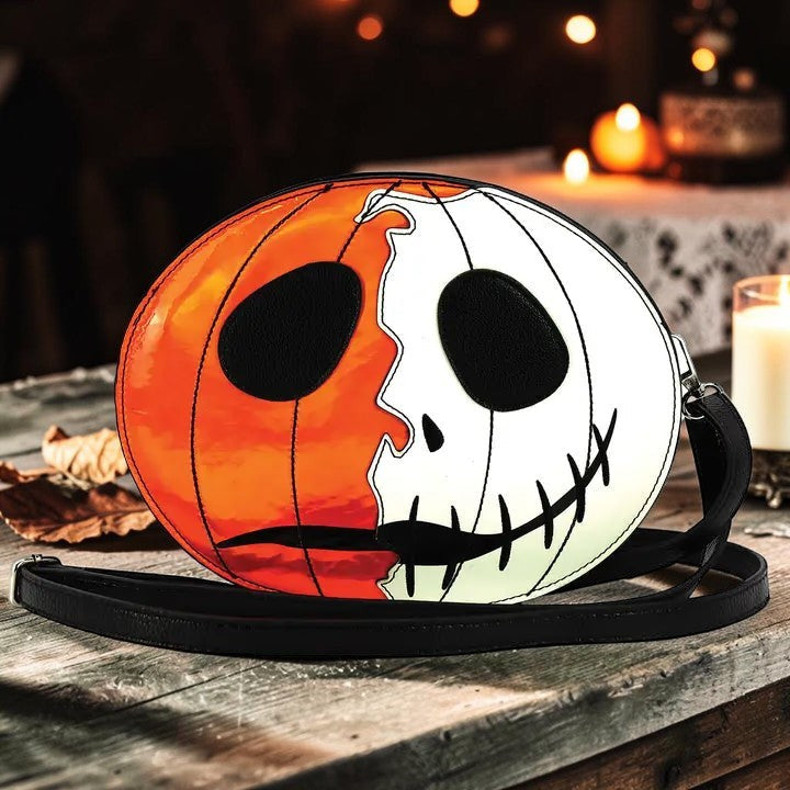 Halloween-Emporium jack-o-lantern crossbody bag with split orange and white face design and adjustable shoulder strap.