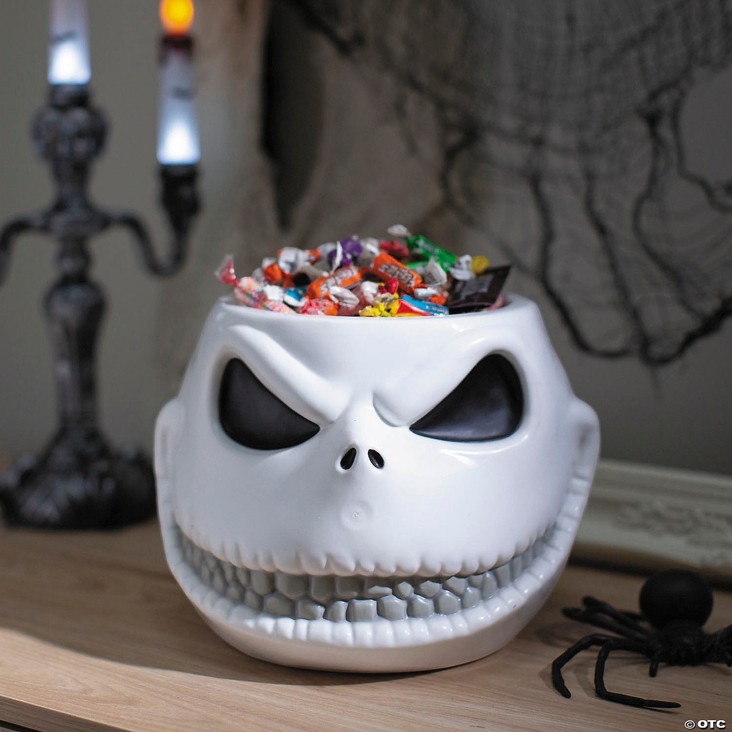 Halloween-Emporium Jack Skellington plastic candy bowl with a white finish and wide grin filled with assorted sweets.