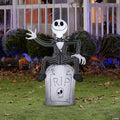 Halloween-Emporium 42-inch Jack Skellington inflatable sitting on a RIP tombstone for outdoor Halloween decor