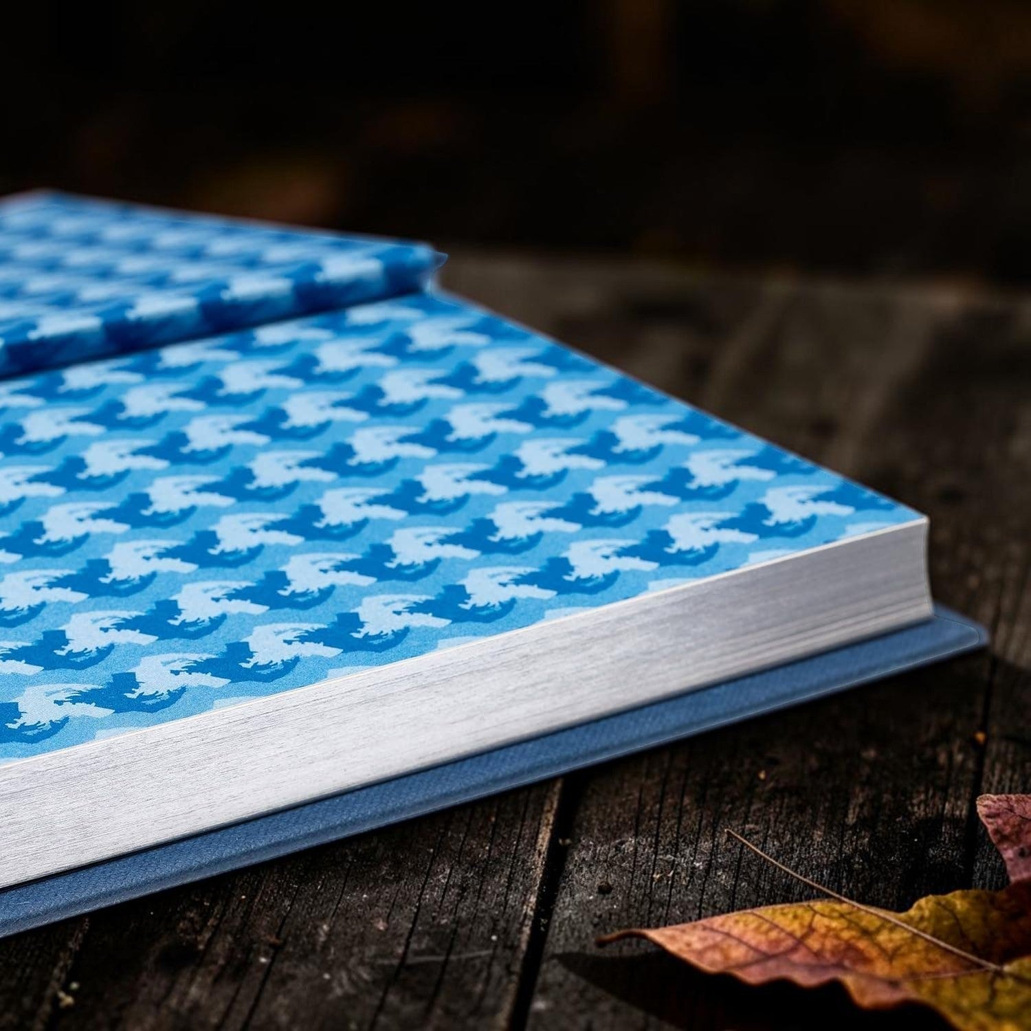 Halloween-Emporium Dr Jekyll and Mr Hyde hardcover book with blue patterned endpapers resting on a rustic wooden surface