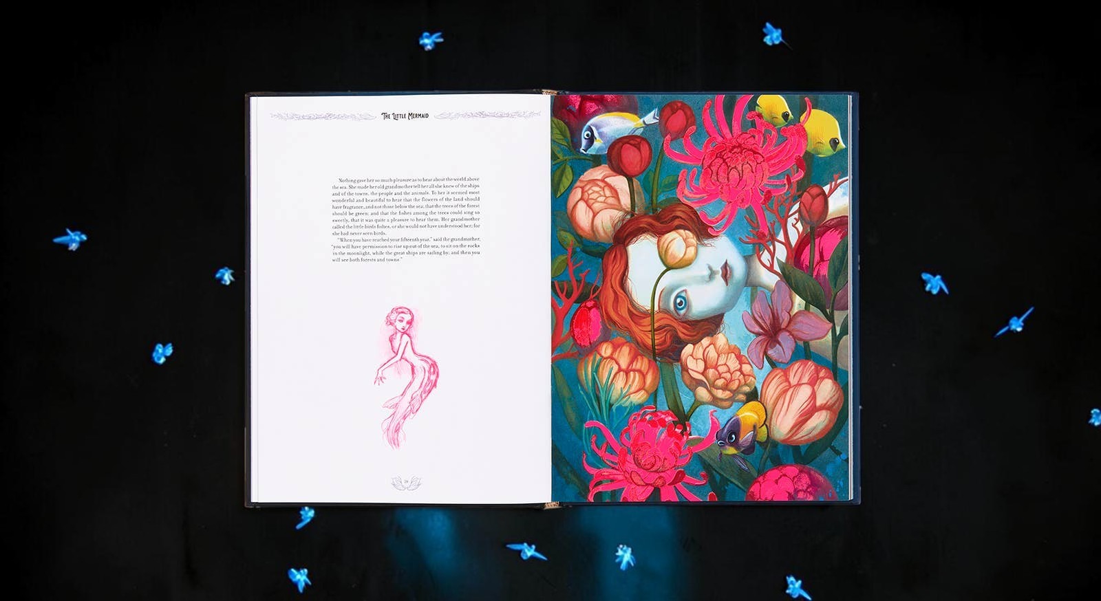 Halloween-Emporium The Little Mermaid hardcover book open to Benjamin Lacombe's surreal, vibrant floral illustrations.