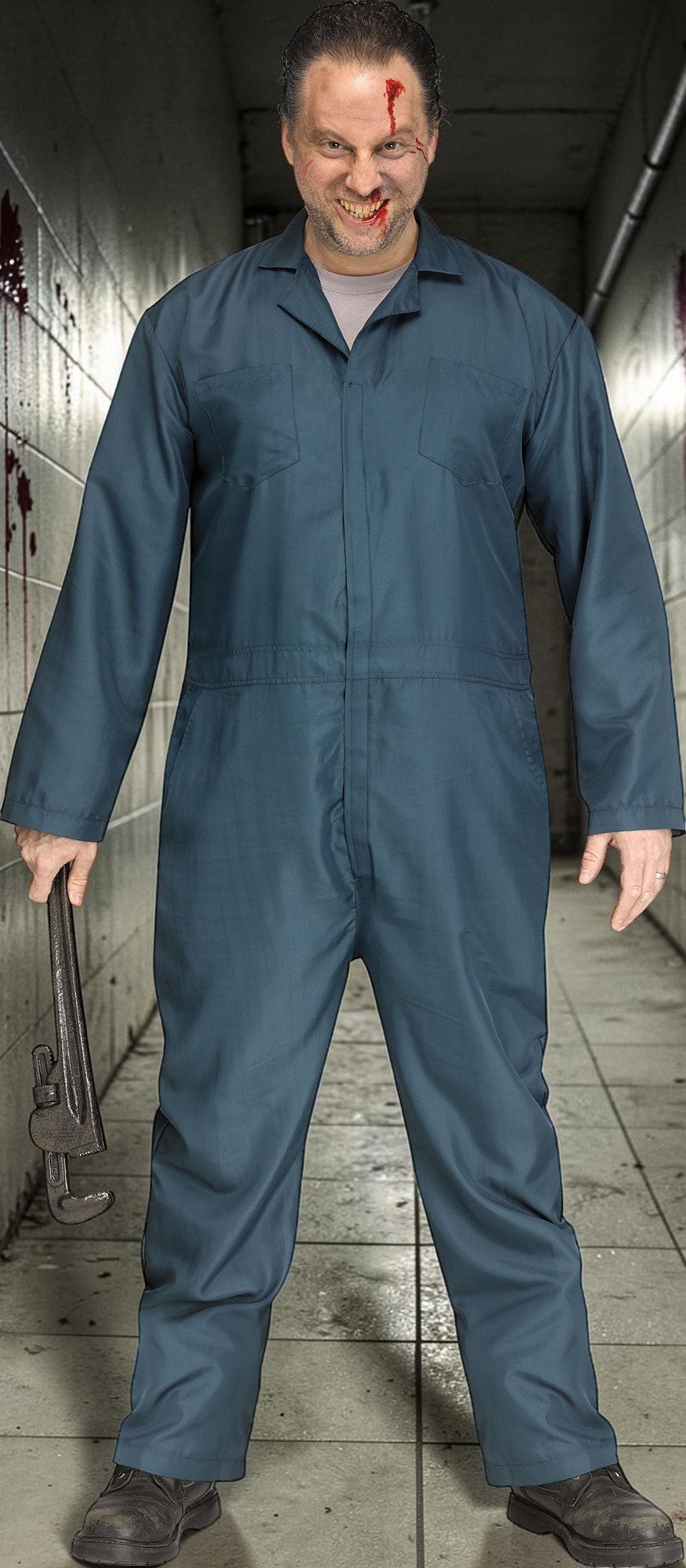 Halloween-Emporium dark blue mechanic coveralls worn by a man with fake blood and a prop wrench in a hallway