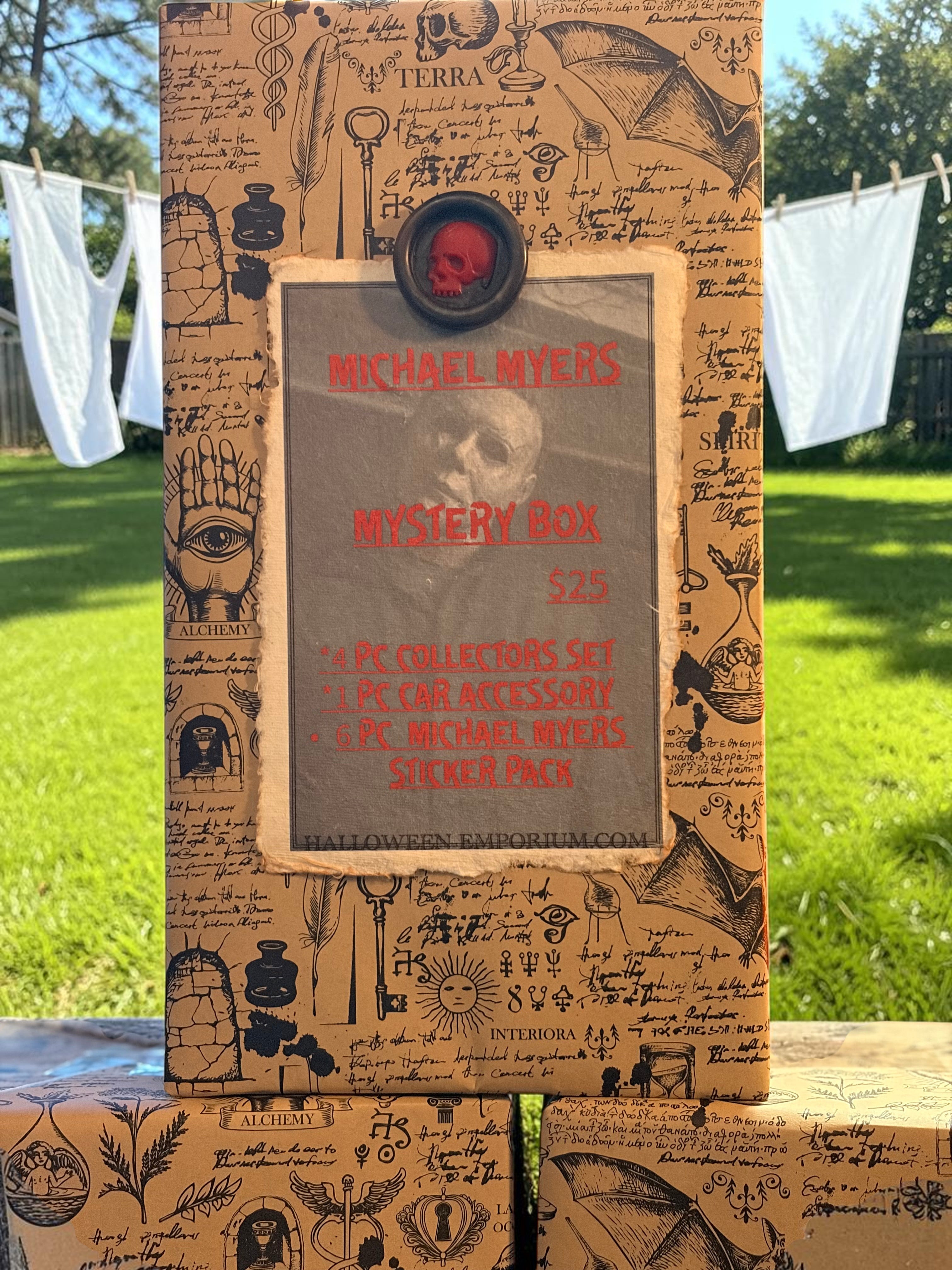 Halloween-Emporium Michael Myers mystery box wrapped in occult-themed paper with a red skull wax seal in a garden.