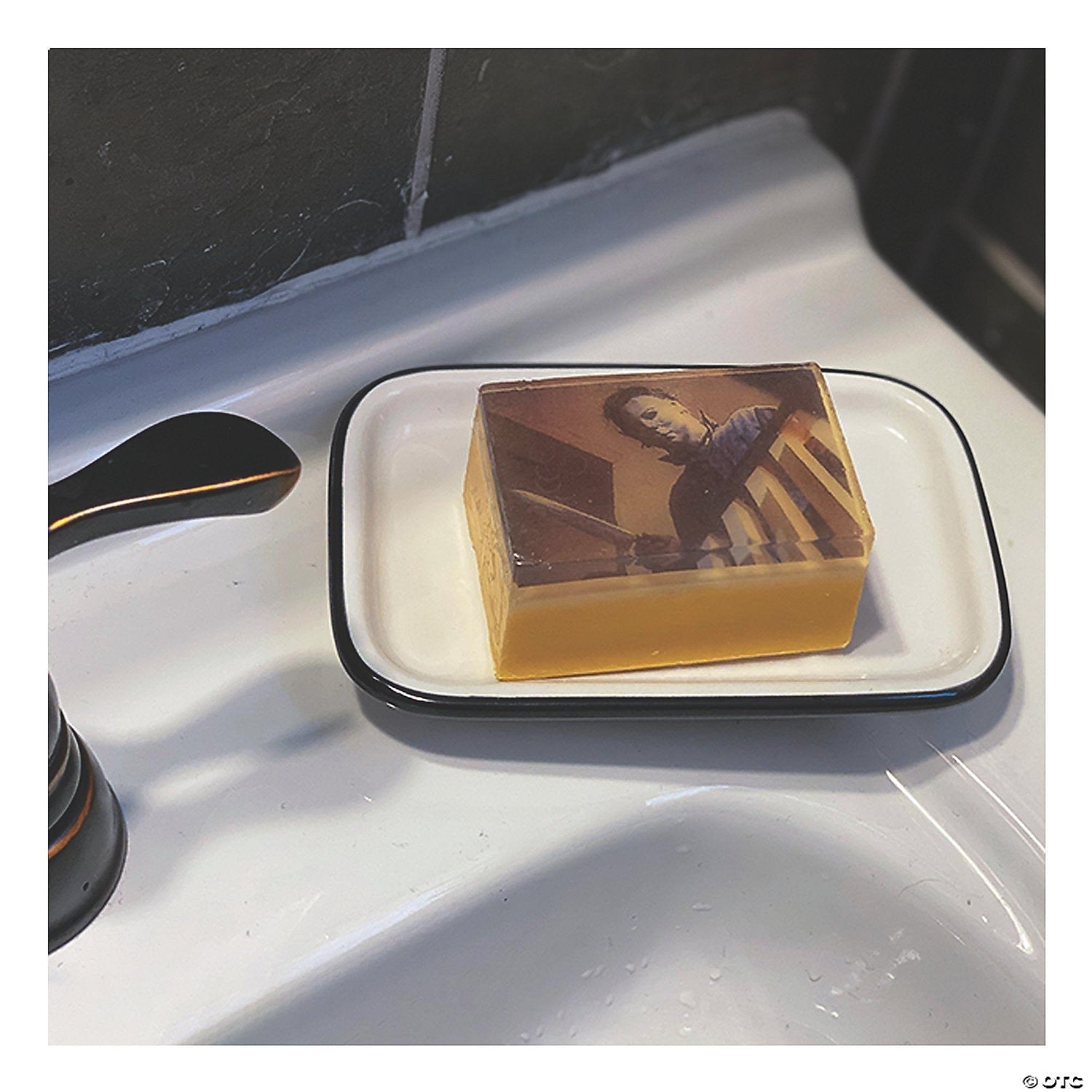 Halloween-Emporium Michael Myers soap bar with an embedded horror movie graphic on a white ceramic soap dish.