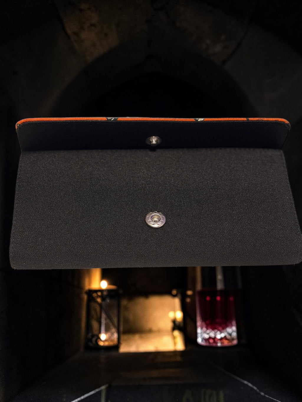 Halloween-Emporium Mummy Clutch Wallet in black with orange trim, featuring a snap button closure for gothic style.