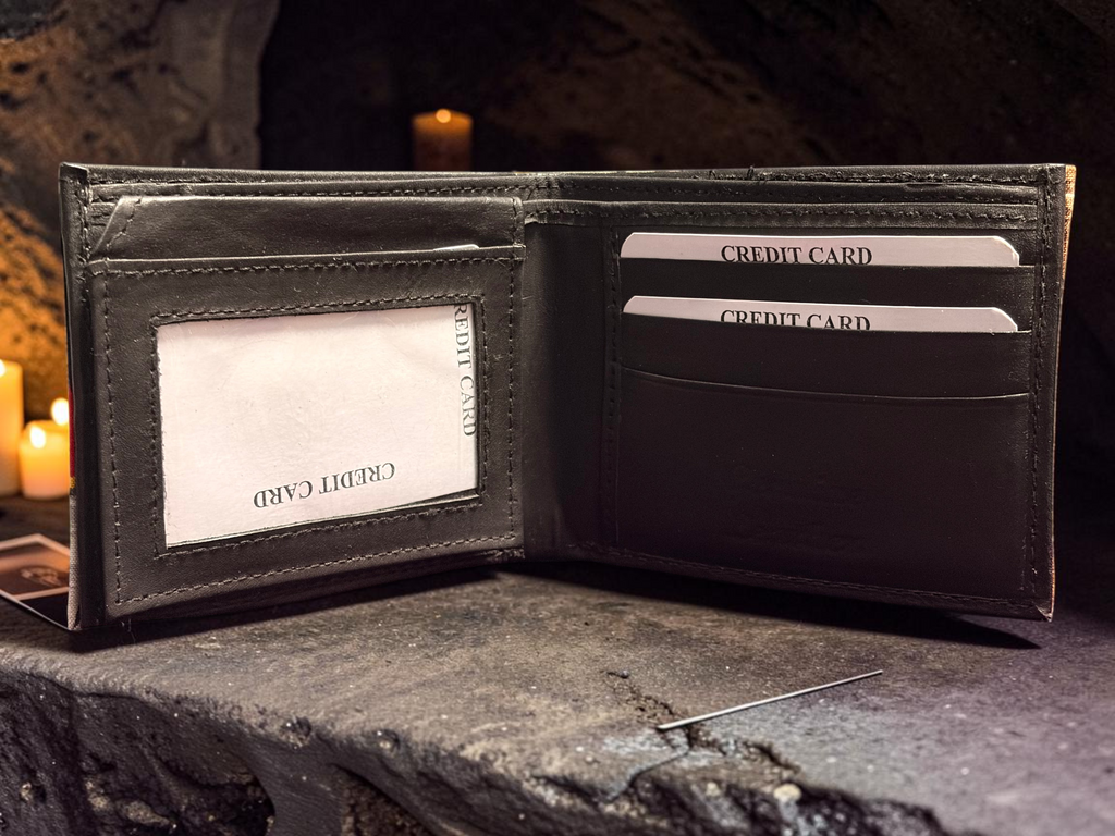 Halloween-Emporium Mummy hand crafted leather wallet open to show card slots and ID window on a stone surface