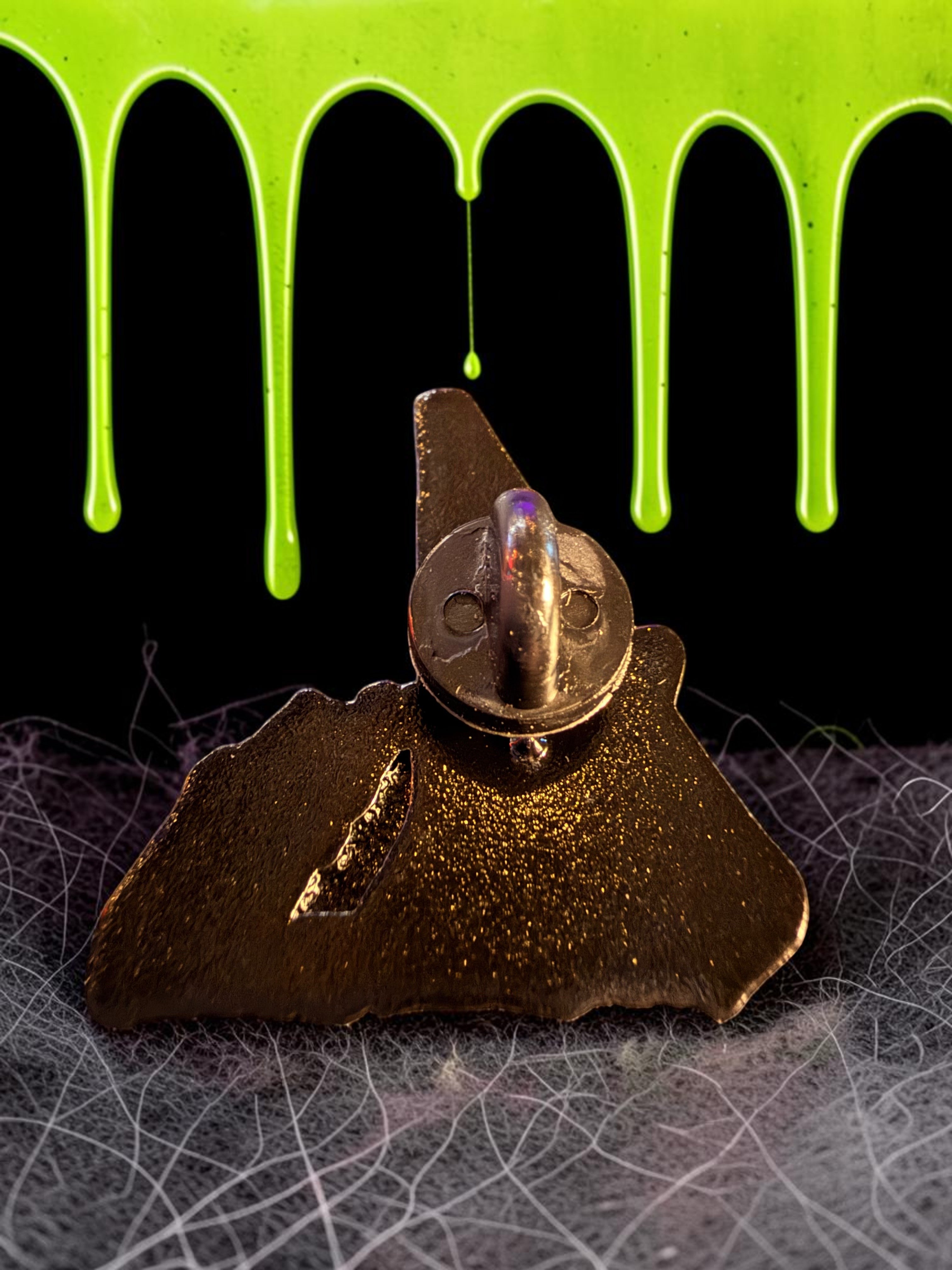 Halloween-Emporium Nando the Relentless enamel pin back view showing the secure metal clutch and pin post