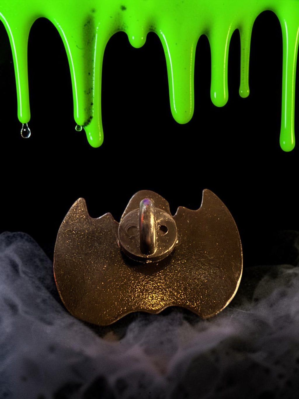 Halloween-Emporium Nandor the Relentless enamel pin back view with secure metal clasp against a spooky slime background