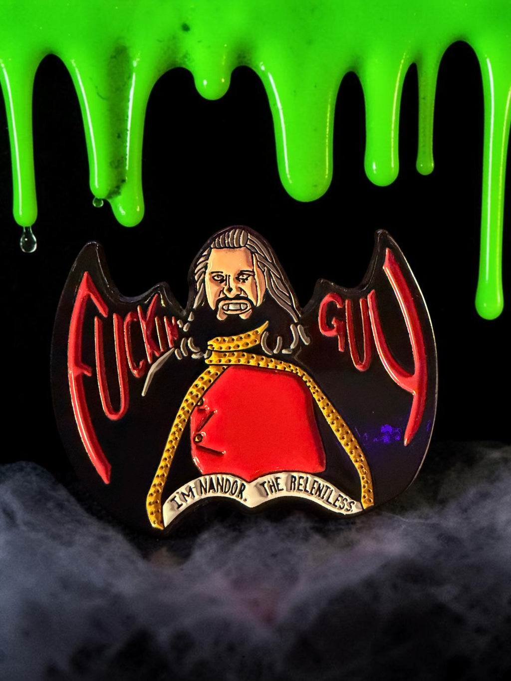 Halloween-Emporium Nandor the Relentless enamel pin featuring red and gold details against a spooky green slime background