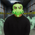Halloween-Emporium neon green full face gas mask costume accessory worn by a person in a dark industrial setting