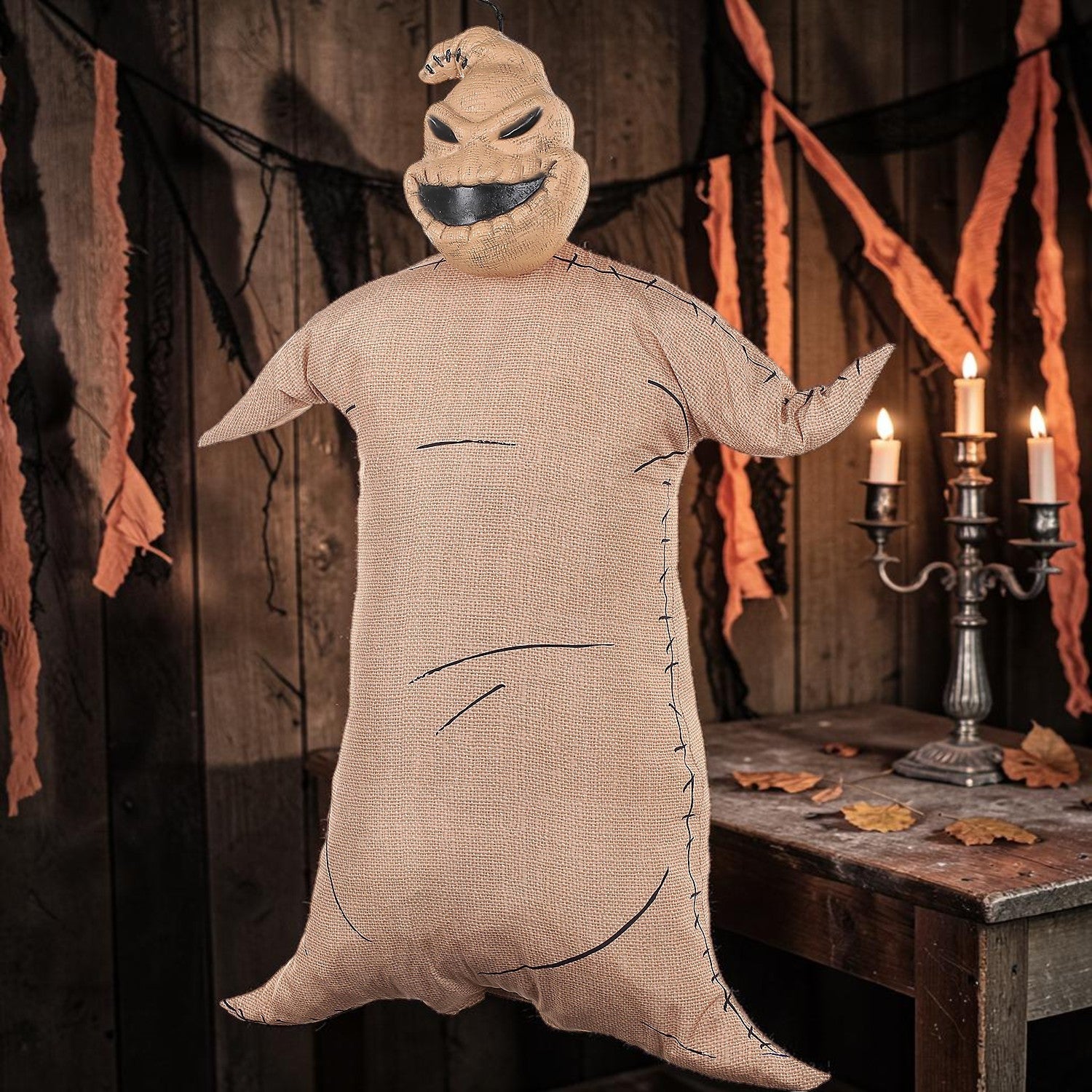 Halloween-Emporium Oogie Boogie hanging decoration made of tan burlap with black stitched details for Halloween decor.