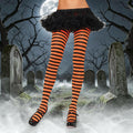 Halloween-Emporium orange and black horizontal striped costume tights worn with a black tutu in a graveyard setting.
