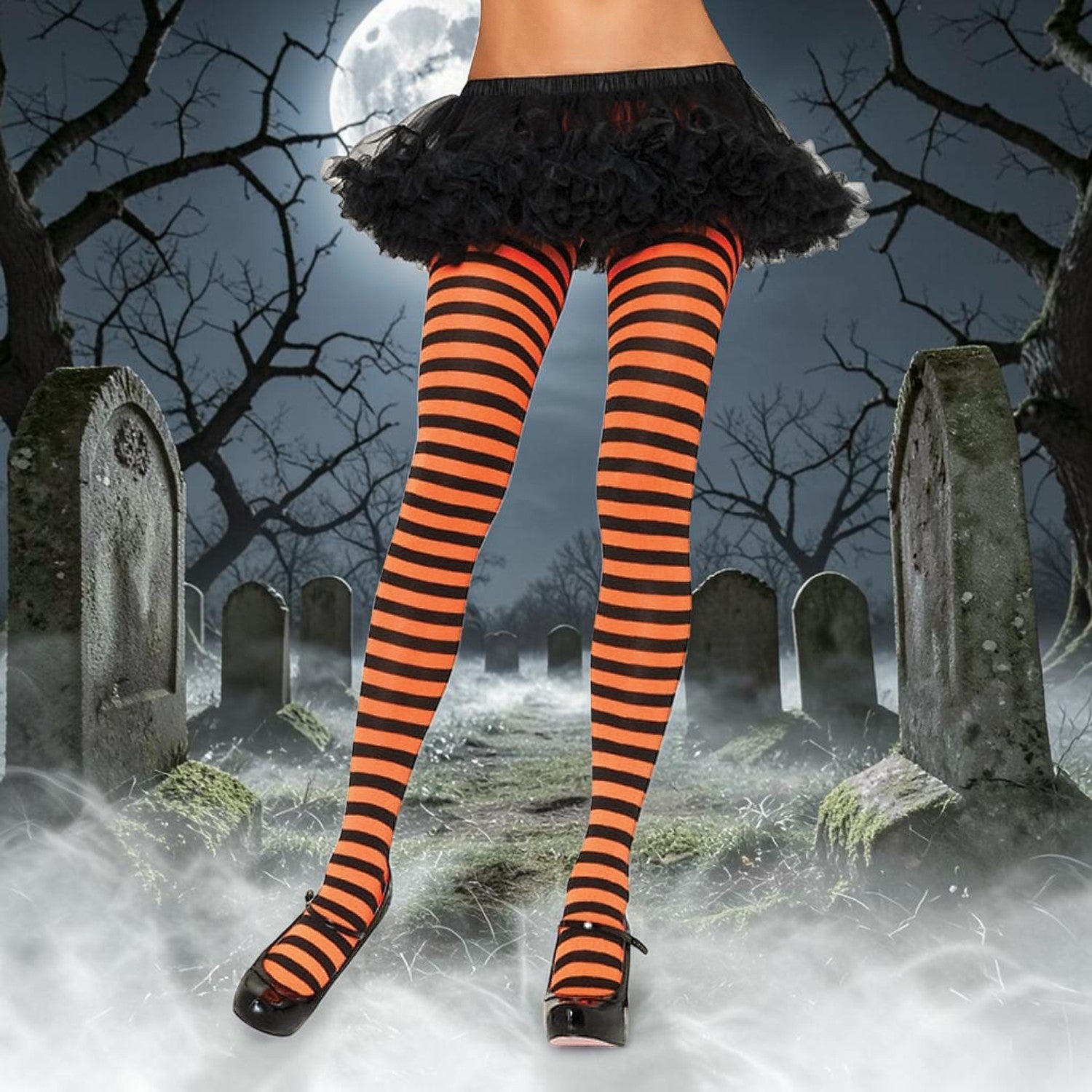 Halloween-Emporium orange and black horizontal striped costume tights worn with a black tutu in a graveyard setting.