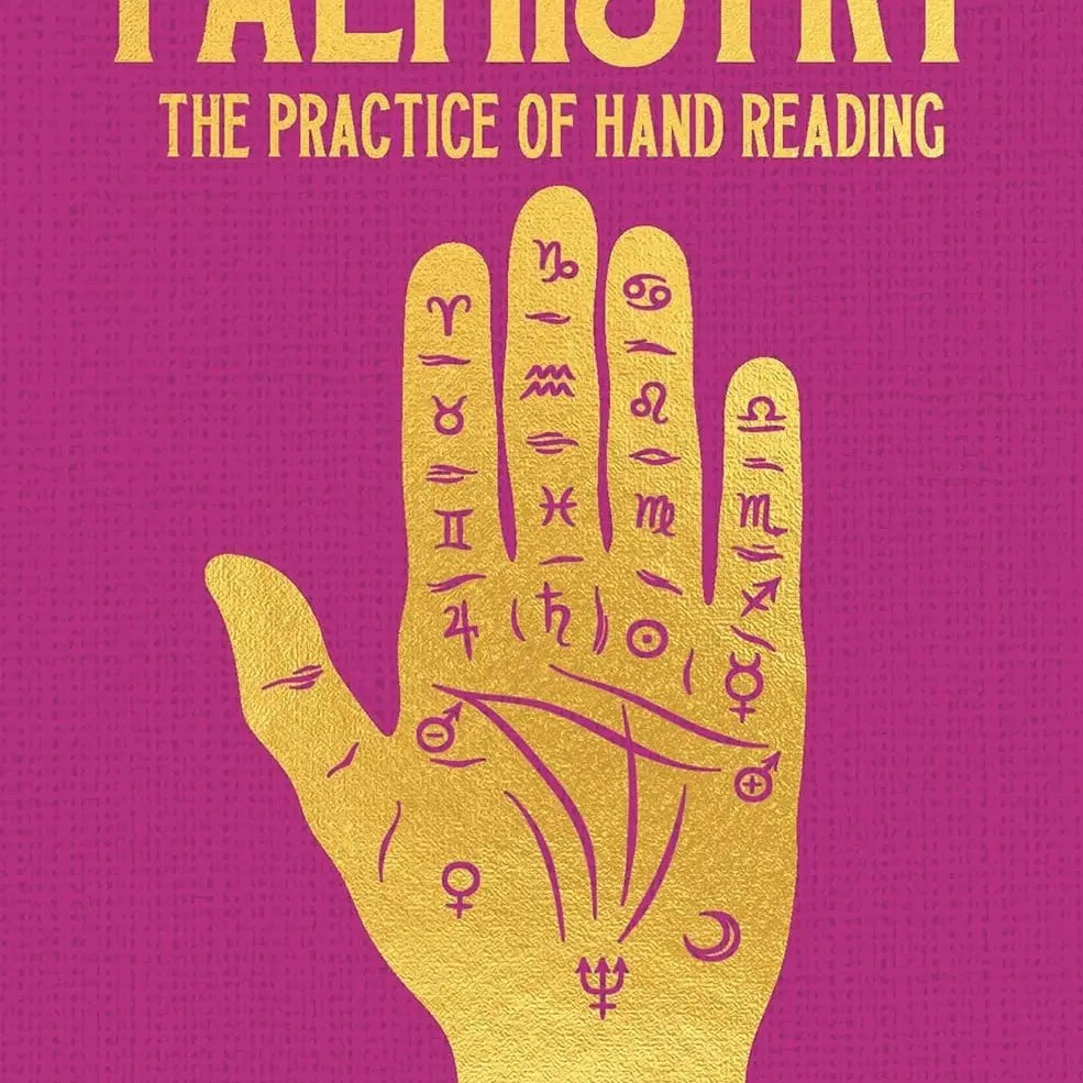 Halloween-Emporium Palmistry hardback book with gold foil hand illustration on a textured magenta cover