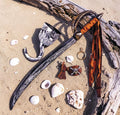 Halloween-Emporium deluxe pirate accessory set with cutlass, hook, skull patch, and earring on sandy beach background.