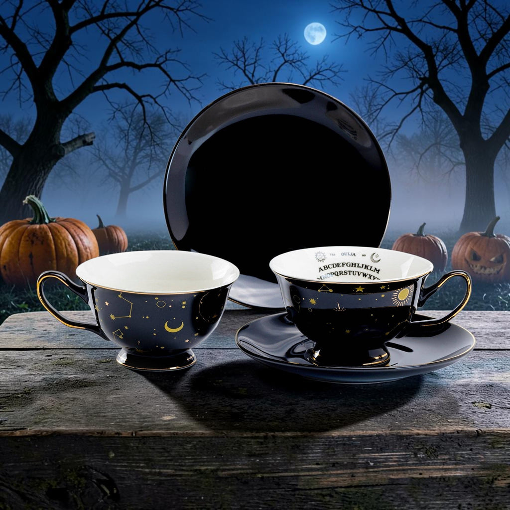 Halloween-Emporium porcelain tea cup and saucer set in black with gold celestial motifs and Ouija board interior