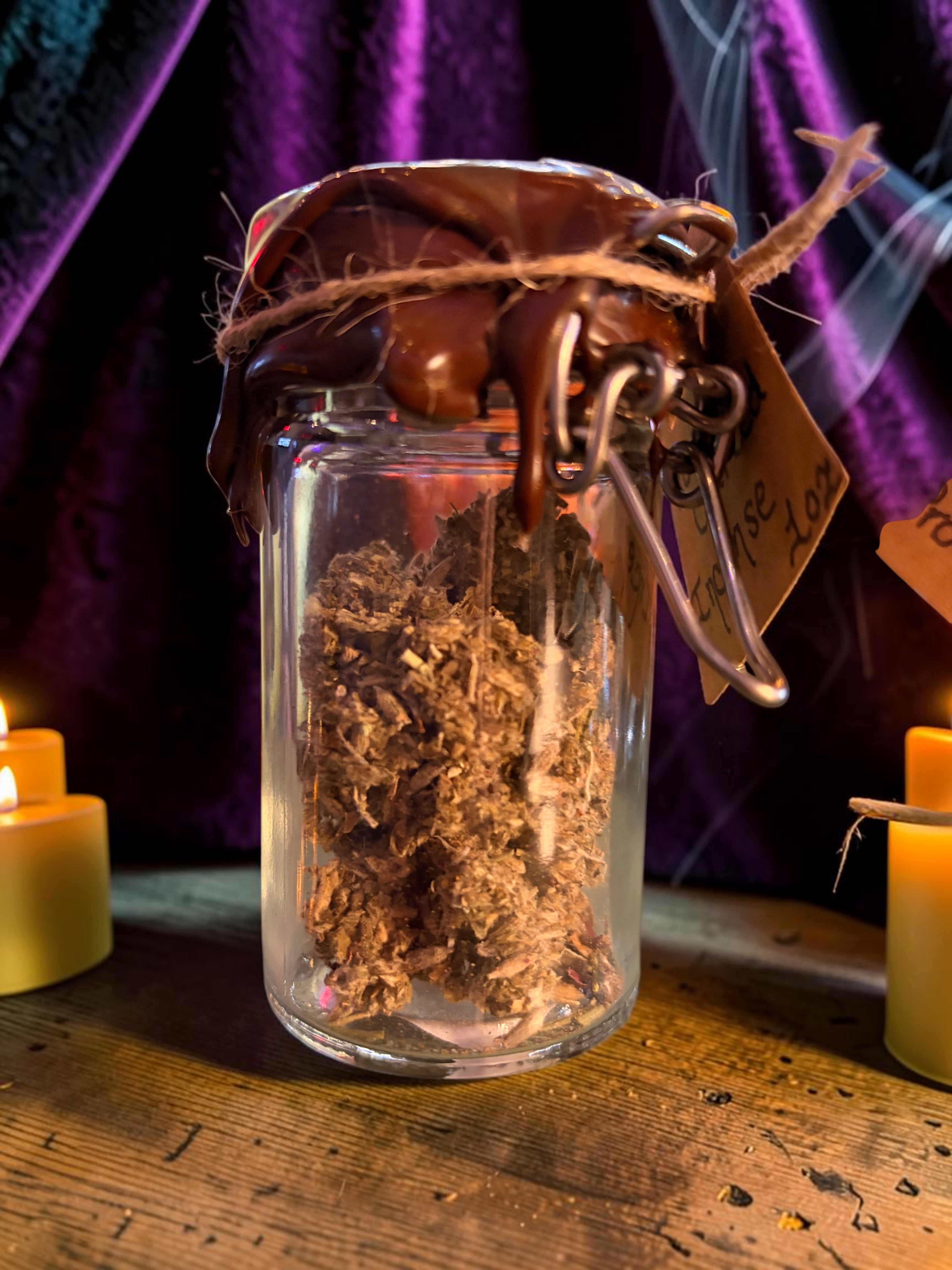 Halloween-Emporium Prosperity and Protection incense blend in a wax-sealed glass jar with ritual herbs and smoke