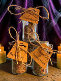 Halloween-Emporium Prosperity and Protection incense jars with natural herbs, twine tags, and ritual smoke.