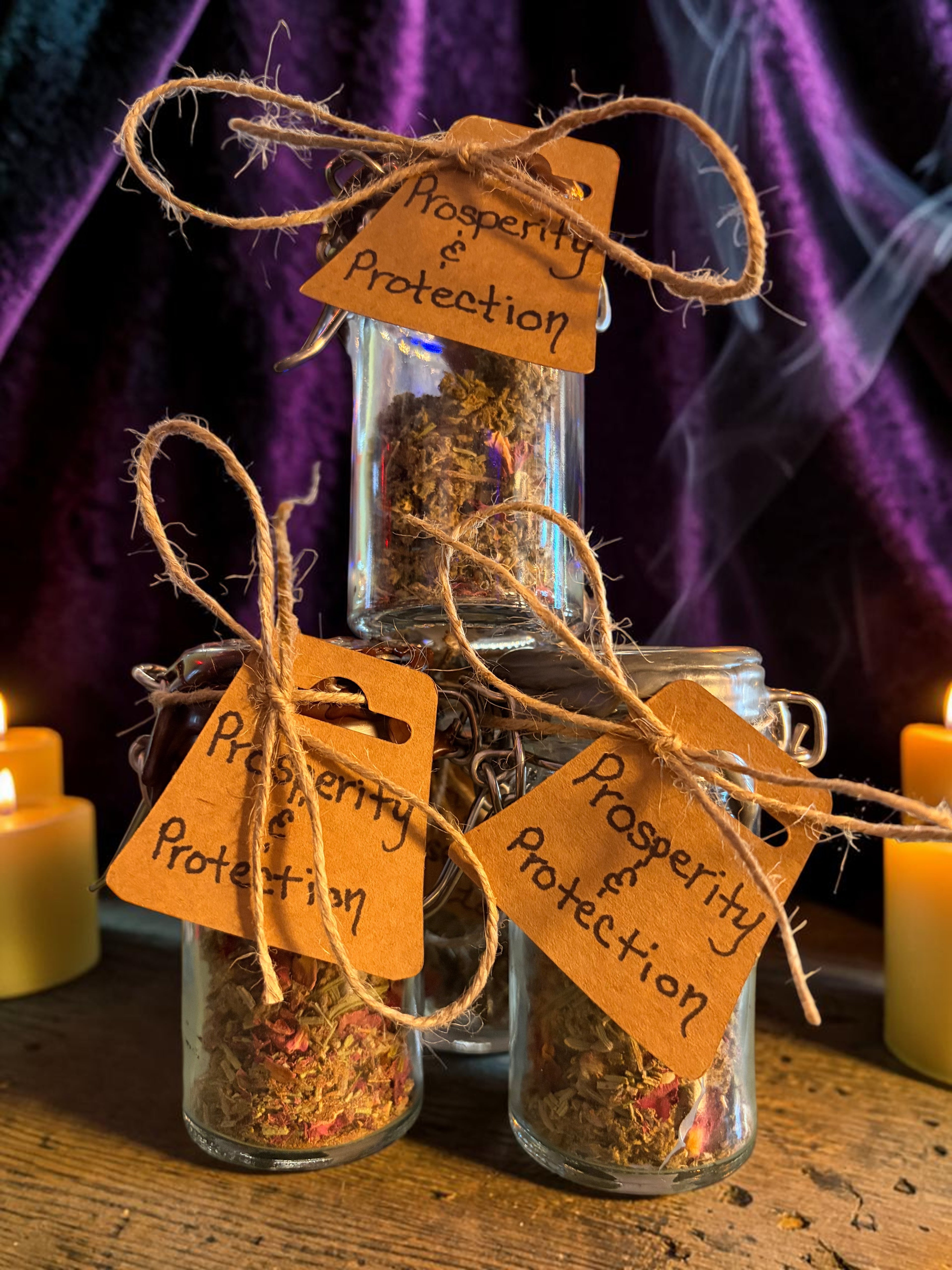 Halloween-Emporium Prosperity and Protection incense jars with natural herbs, twine tags, and ritual smoke.