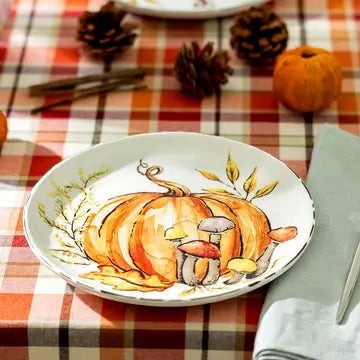Halloween-Emporium ceramic salad plate featuring a hand-painted orange pumpkin and forest mushrooms on a plaid tablecloth