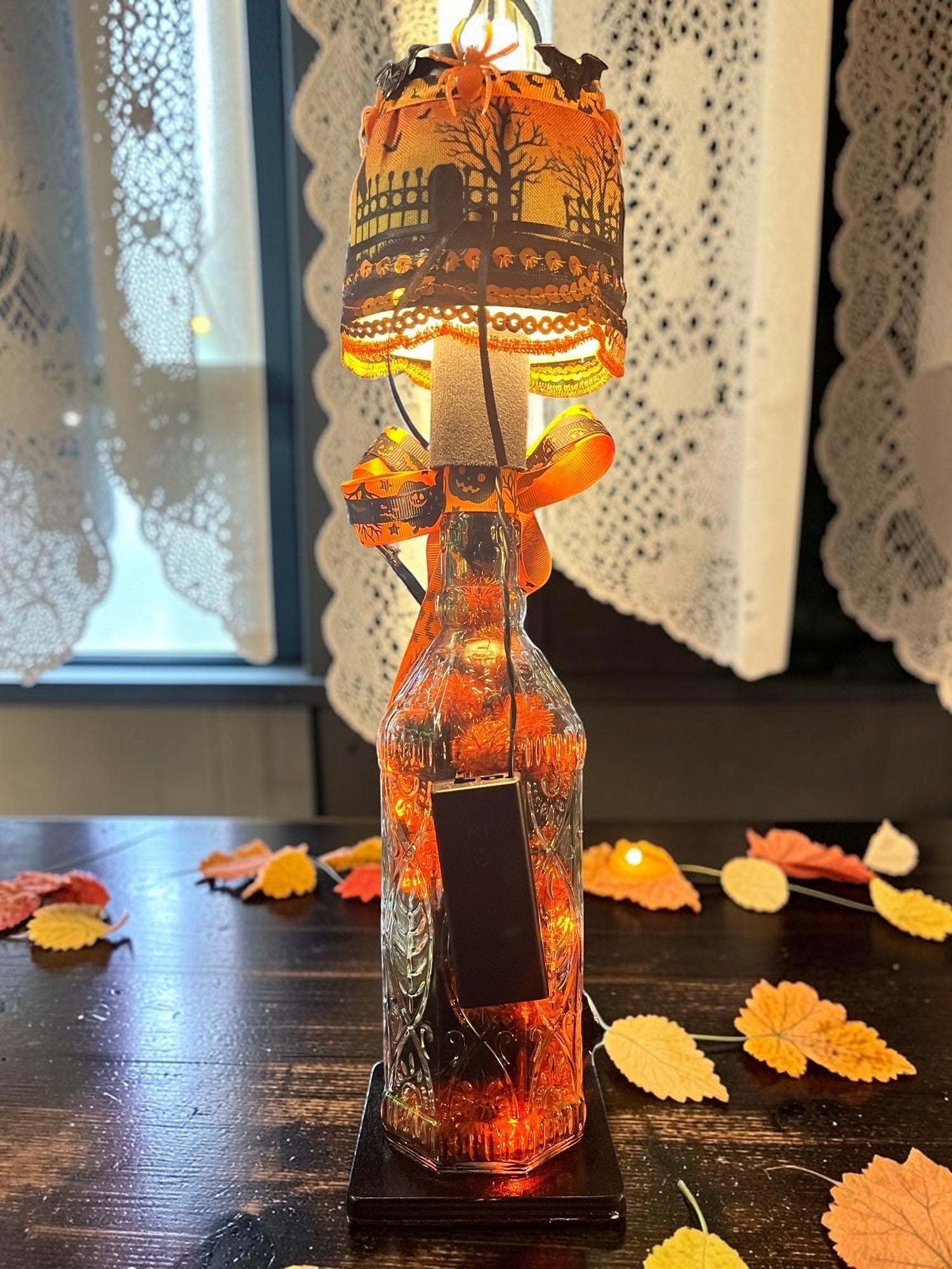 Halloween-Emporium Randy Hendrickson handcrafted LED bottle lamp with orange spooky shade and battery-operated lights