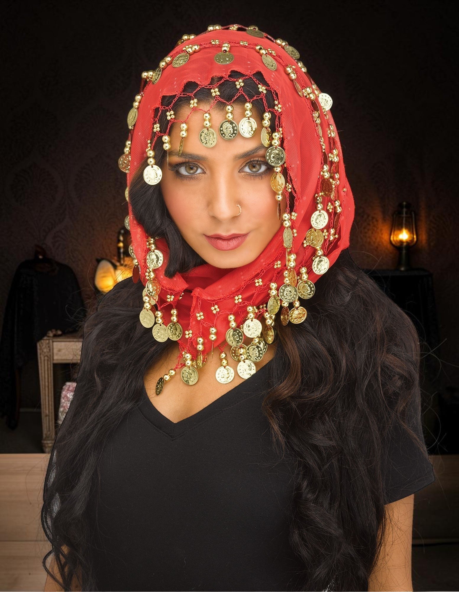 Halloween-Emporium red headpiece with gold coins worn by a woman for a belly dance or fortune teller costume look