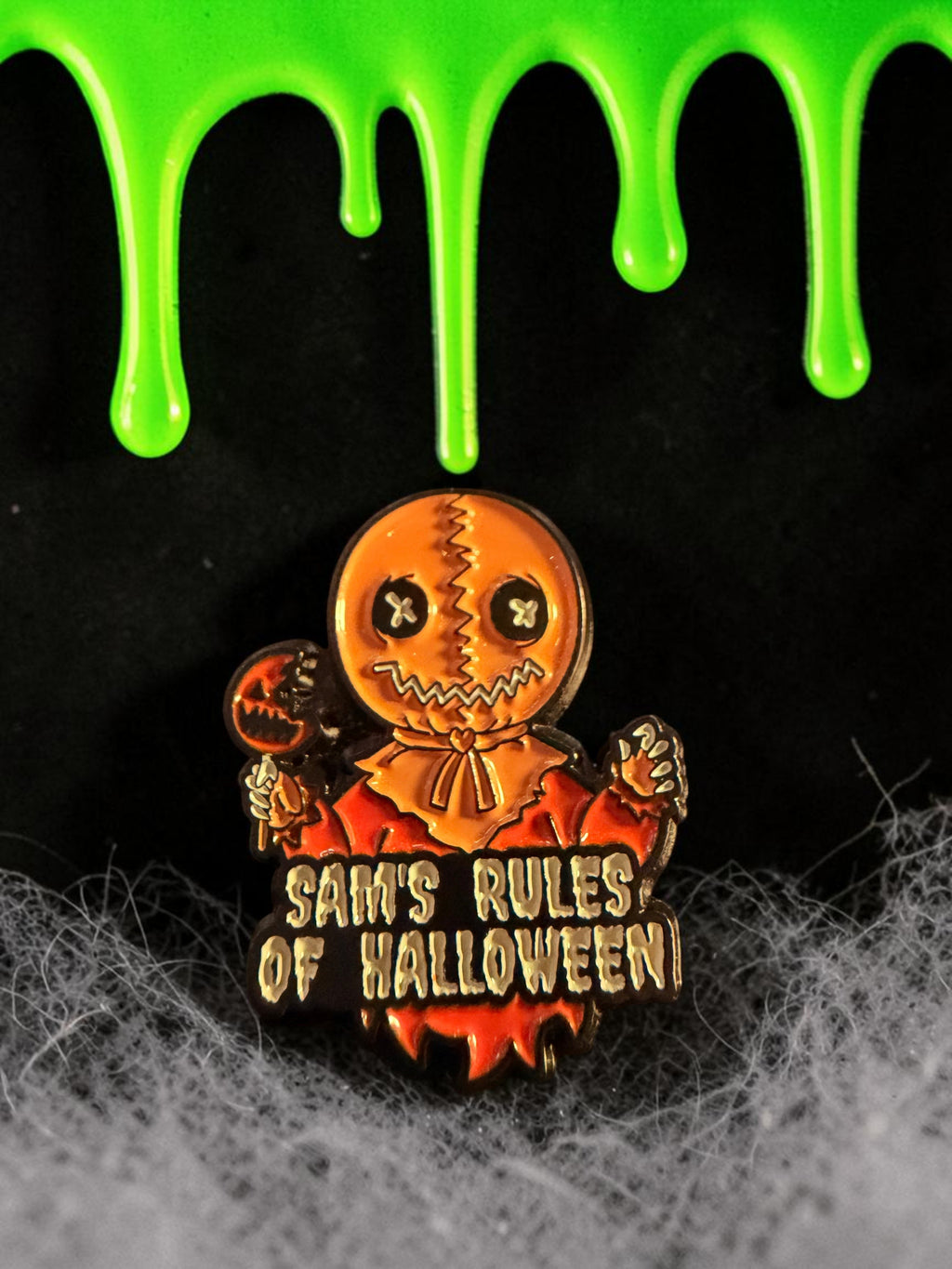 Halloween-Emporium Trick 'r' Treat Sam enamel pin featuring the character holding a lollipop with text below.