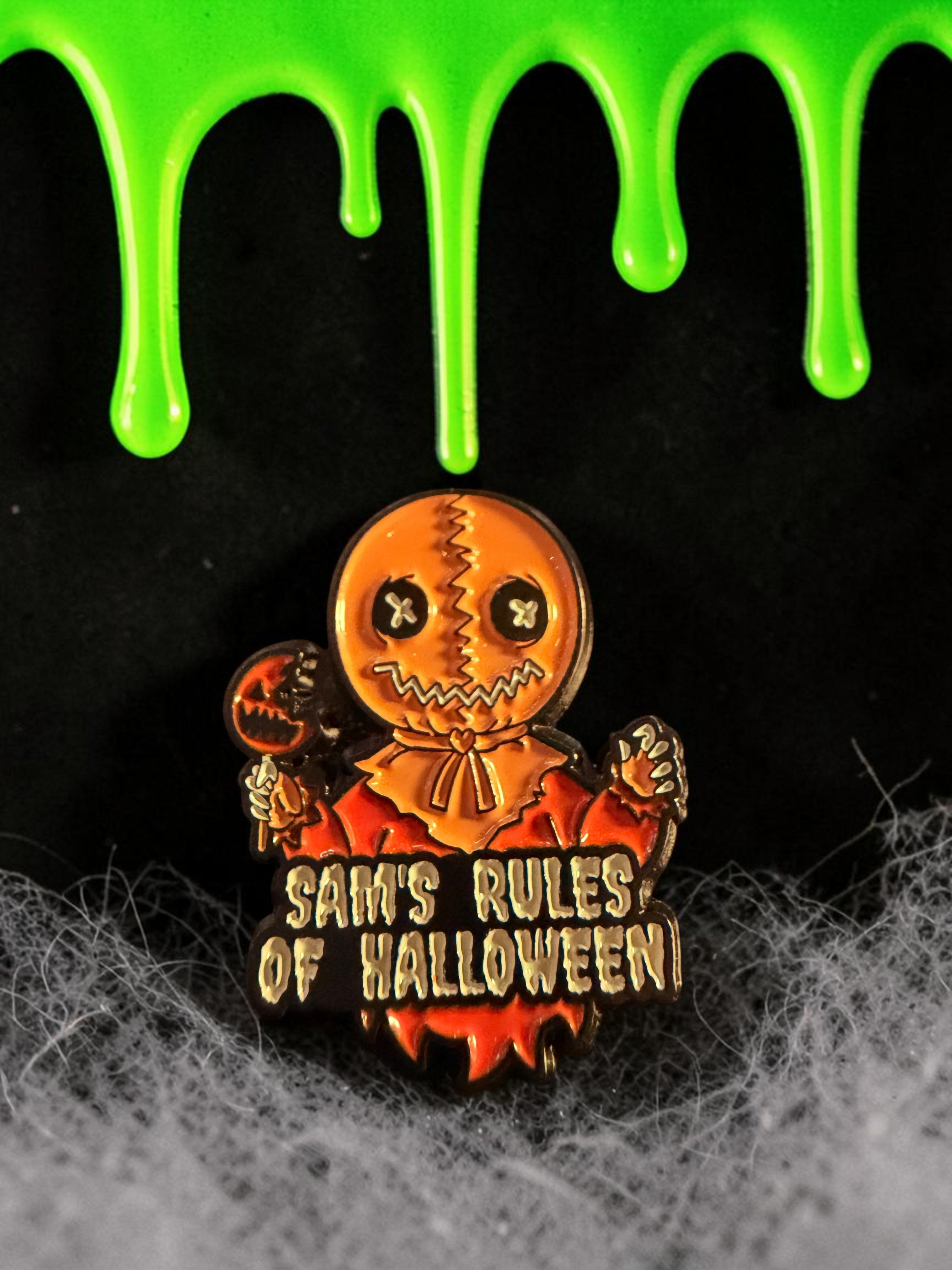 Halloween-Emporium Trick 'r' Treat Sam enamel pin featuring the character holding a lollipop with text below.