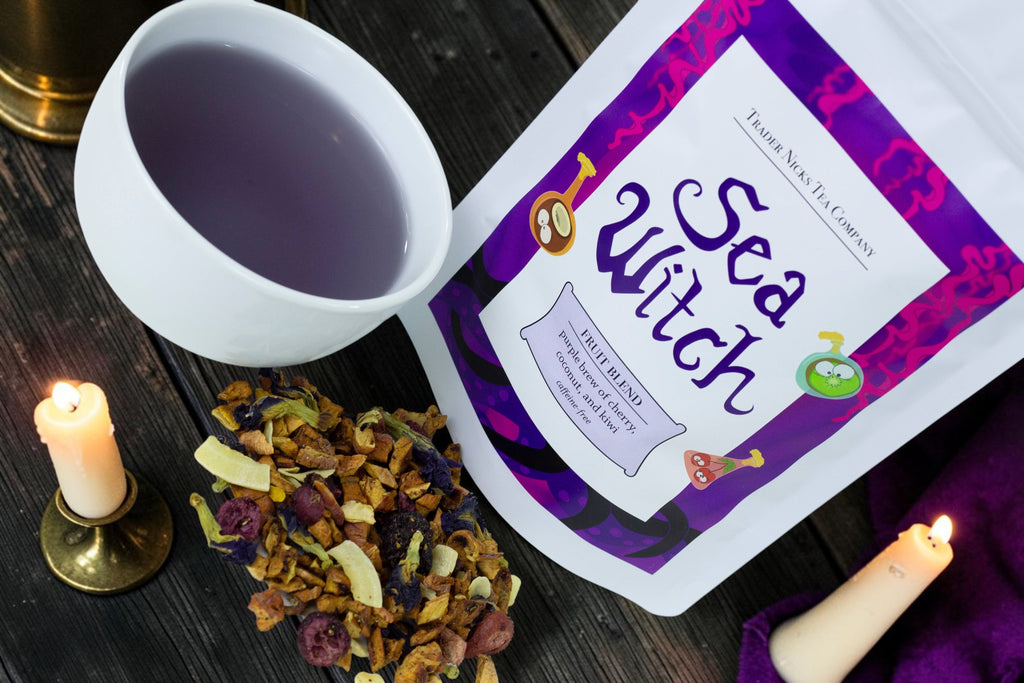 Halloween-Emporium Sea Witch cherry coconut fruit tea blend with a cup of purple brewed tea and candles