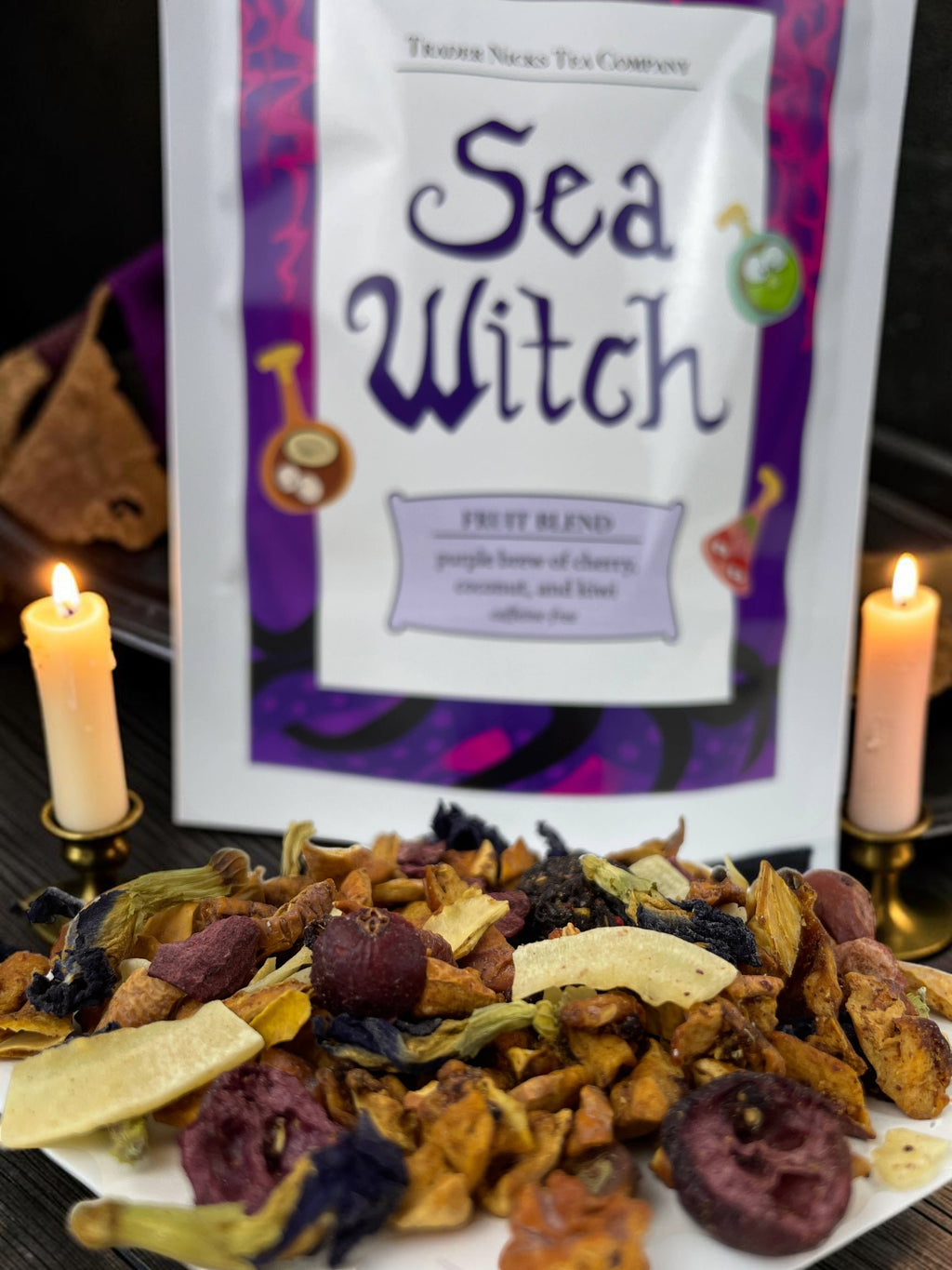 Halloween-Emporium Sea Witch fruit tea blend with dried cherries, coconut, and butterfly pea blossoms in front of a pouch