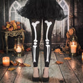 Halloween-Emporium black opaque tights with a white skeleton leg bone print worn with a black tutu and heels.