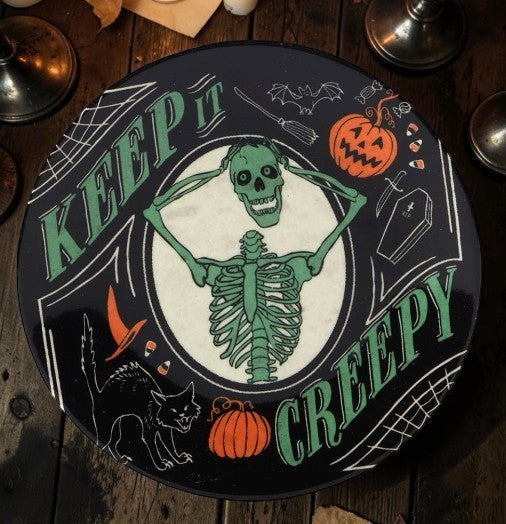 Halloween-Emporium 6-inch round canape plate featuring a green skeleton, black cat, and jack-o'-lantern design.
