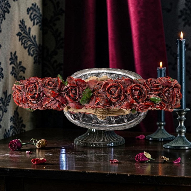 Halloween-Emporium gothic skeleton couple figurine embraced by a vibrant red rose heart on an ornate Celtic base.