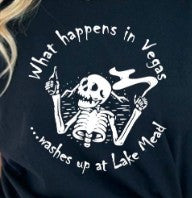 Halloween-Emporium black cotton crewneck t-shirt featuring a white skeleton graphic with the text What happens in Vegas