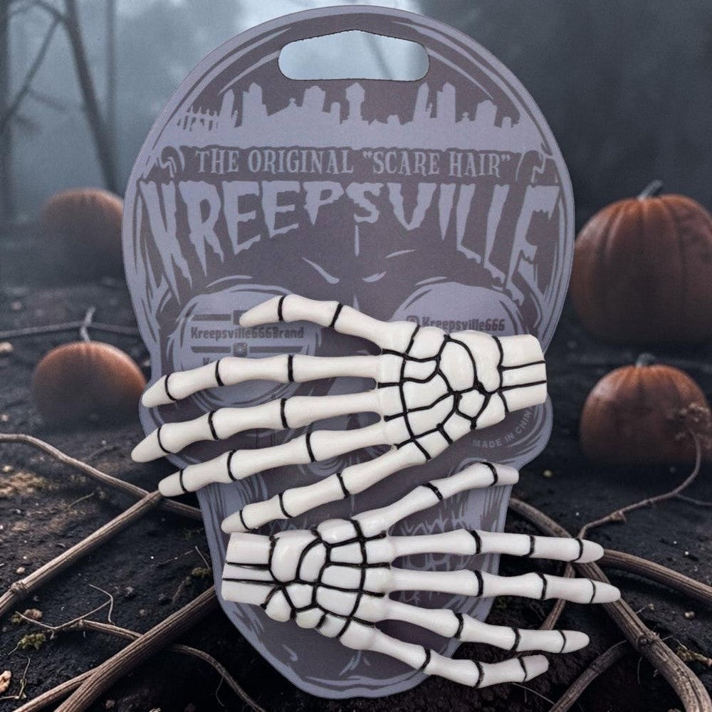 Halloween-Emporium white skeleton bone hand hairslides with black detailing on a branded skull-shaped display card.