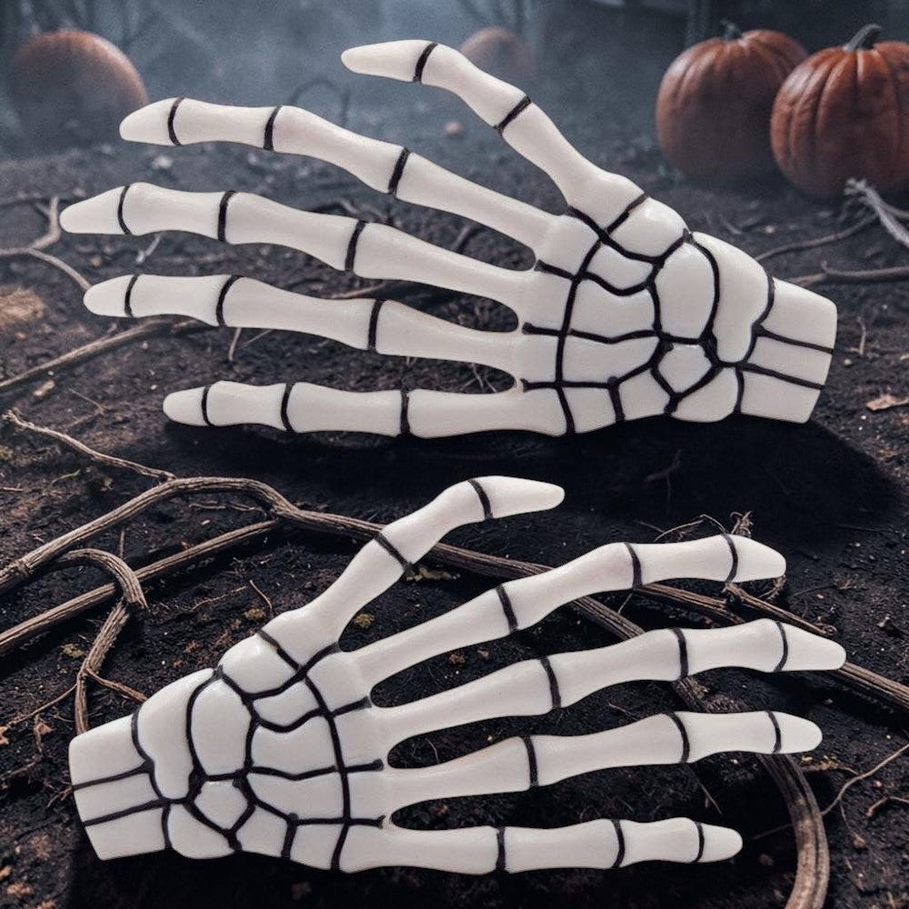 Halloween-Emporium white skeleton bone hand hairslides with black detailing, perfect for gothic or spooky hairstyles.